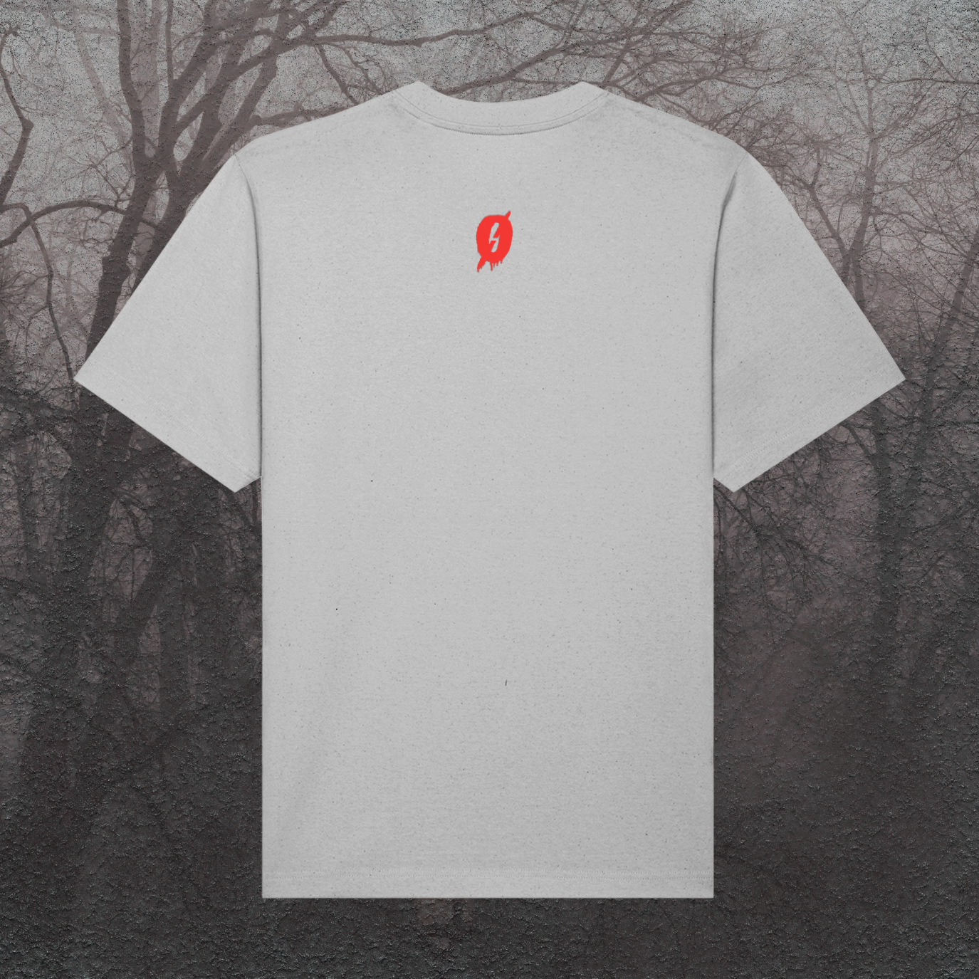 Gray t-shirt with a red logo on the back against a dark, leafless tree background