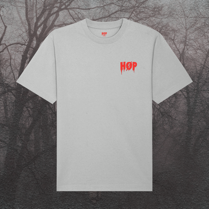 Gray t-shirt with red logo on a dark, leafless tree background